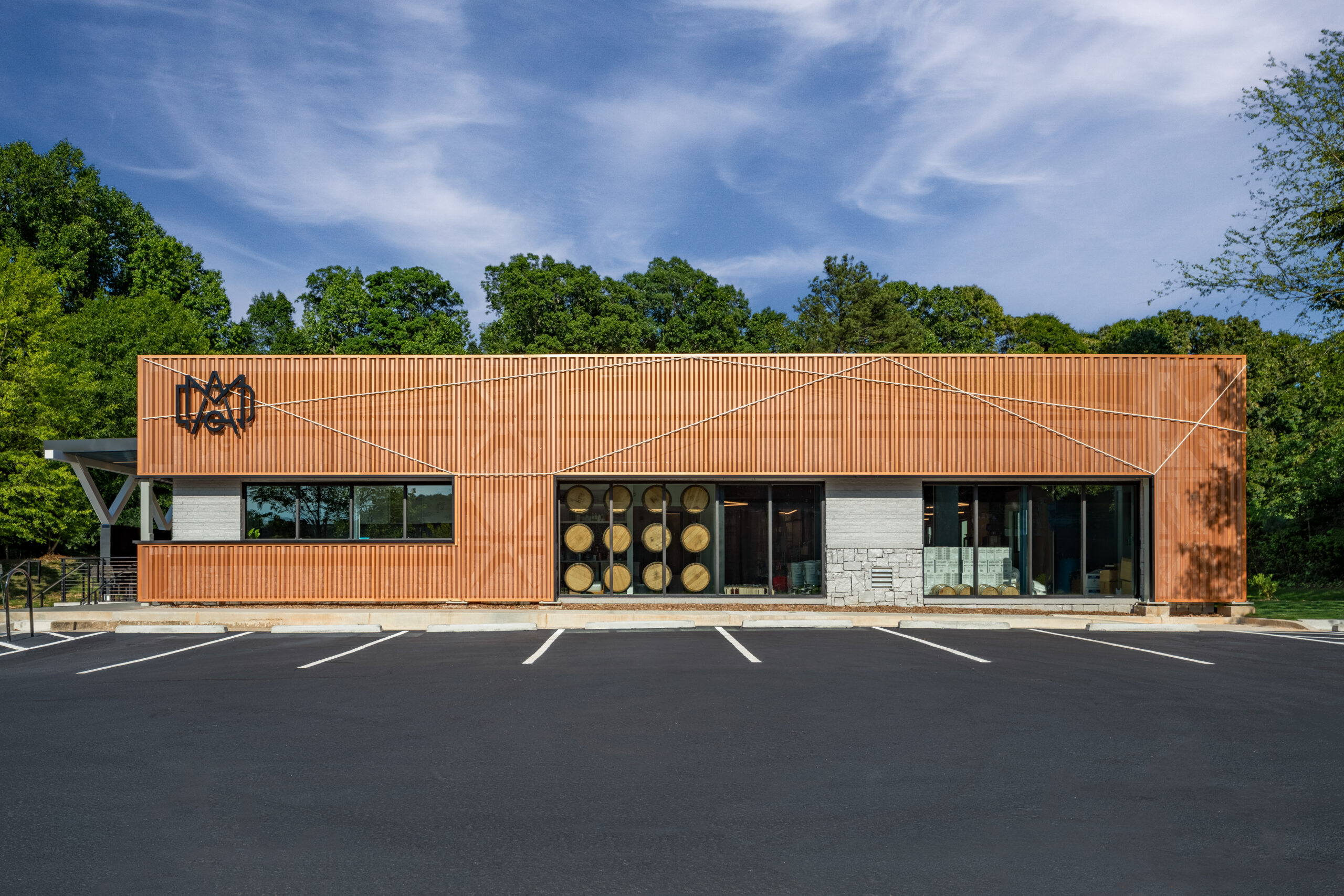 Dramatic photo of a wood-clad distillery and art gallery building